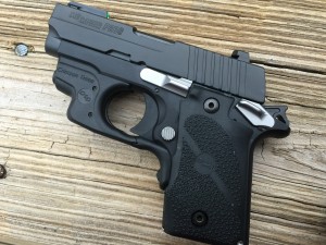 Sig's P238 "Sport" shown with a Crimson Trace laser module installed on the pistol.